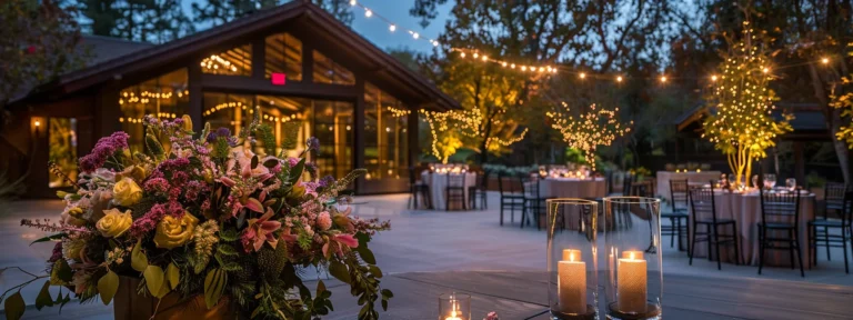 a sophisticated corporate event planner orchestrates an elegant gathering in woodside, ca, showcasing a beautifully arranged venue illuminated by soft, ambient lighting and adorned with lush floral centerpieces.